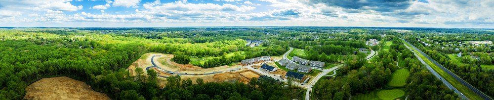 Aerial panorama of communities in wooded area